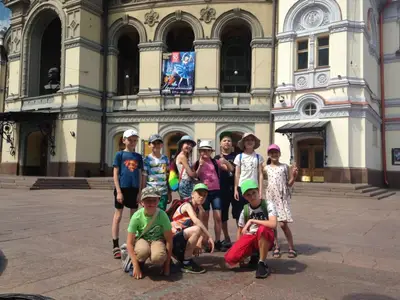 Група школярів на фоні будівлі Національної опери України під час екскурсії за лаштунки театру